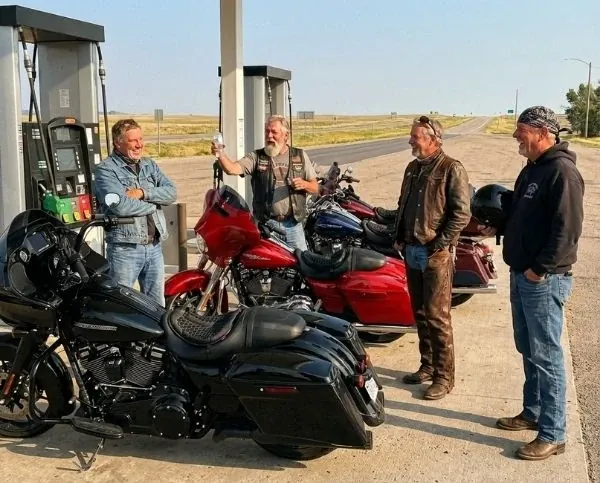 Four riders chatting at the petrol station, bikes fitted with SelleZen